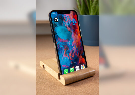 Download iPhone 12 Pro on wooden Stand Mockup | Mockup World